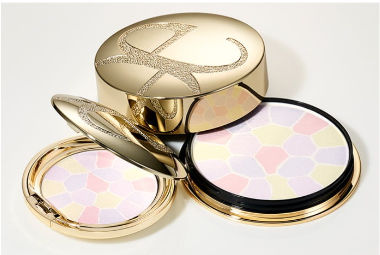 Gold makeup compacts with mosaic powder patterns, open and stacked for display
