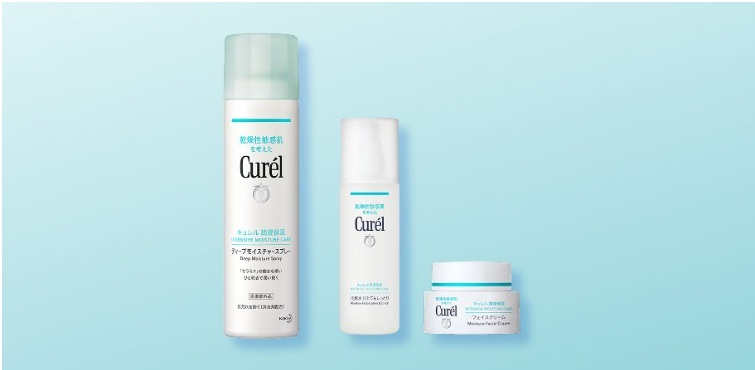 Curél skincare trio: tall spray, white bottle, and small cream jar on a blue gradient background.